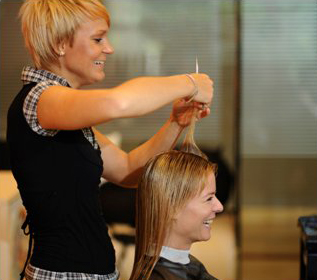 Woman cutting hair at Bellus Academy