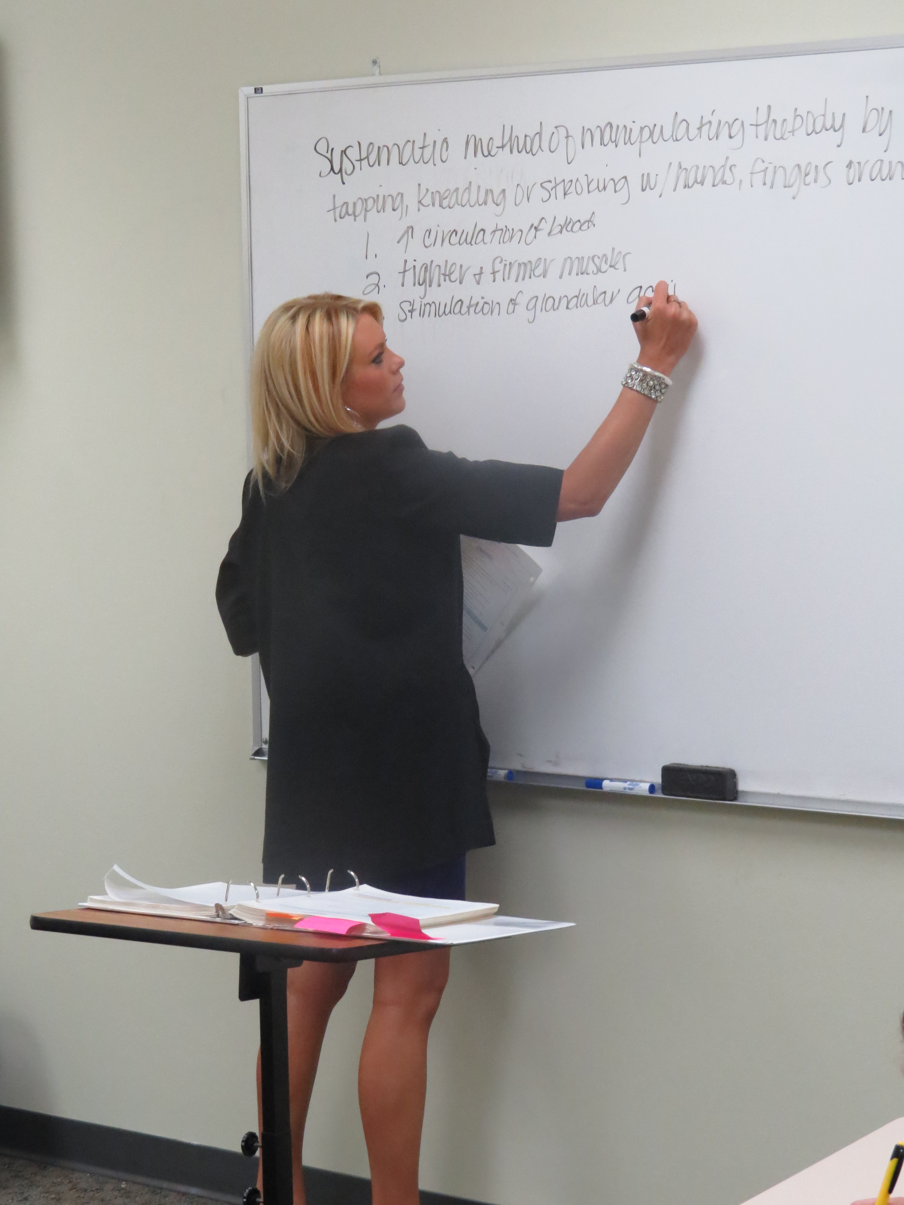 Instructor writing on the whiteboard at Xenon Academy