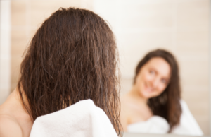 woman drying her hair with towel