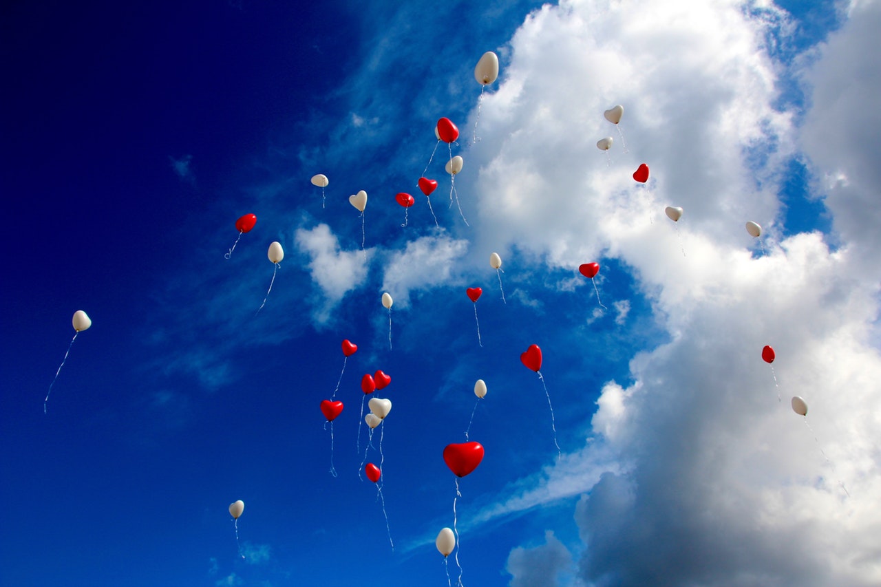 heart balloons being released