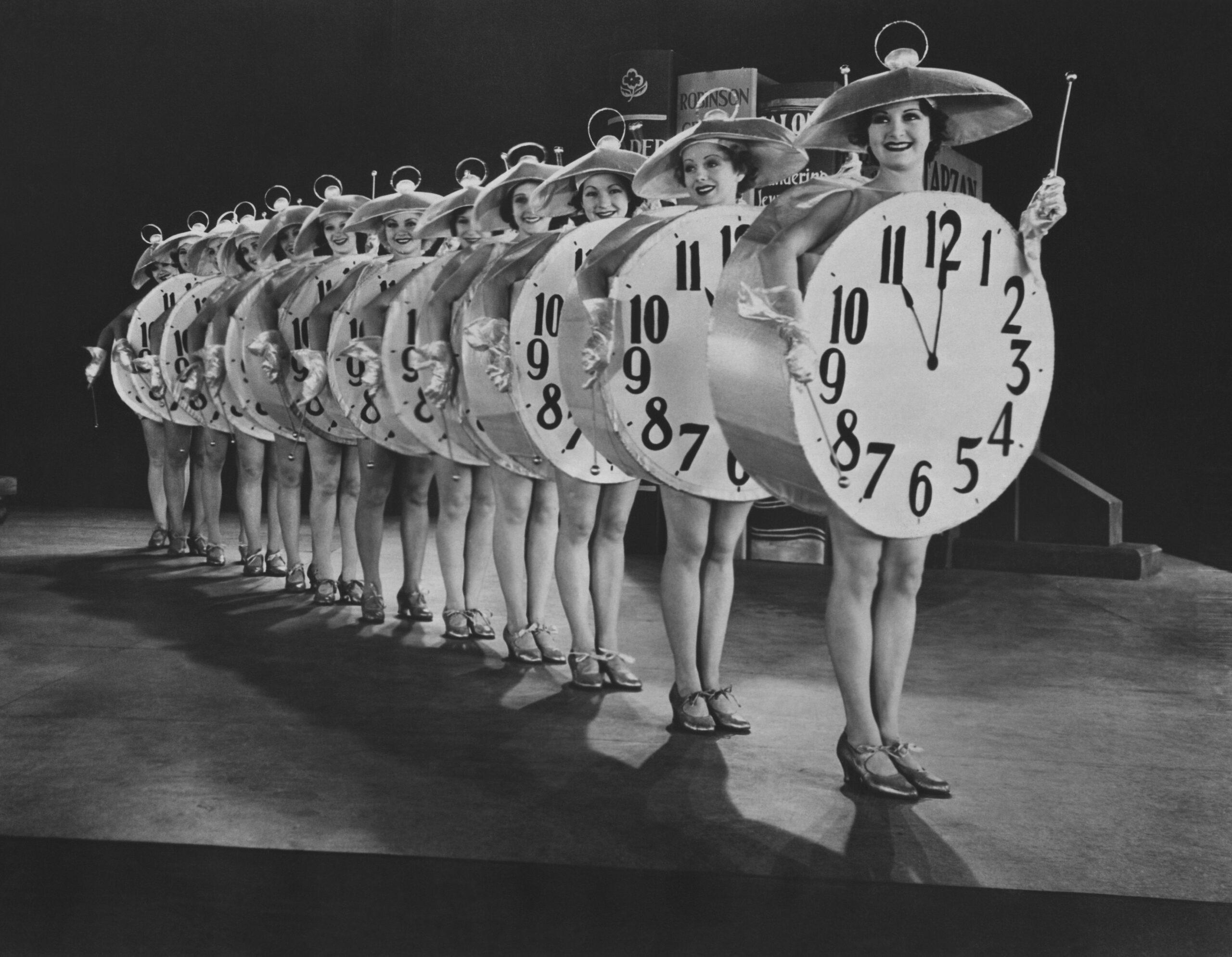 Women dressed as clocks. They are about to tap dance. It is amazing.